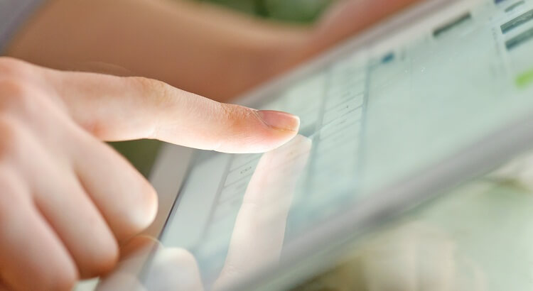 Hand touching screen on modern digital tablet pc.
