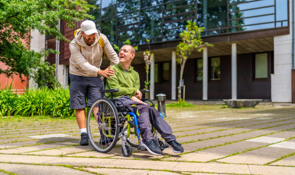 Man with special needs and friend walking along university campus